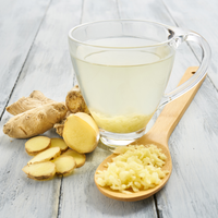 Close-up of Ayurvedic herbs and spices used in teas, including ginger, turmeric, and fennel.